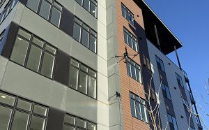 Drone cleaning exterior glass on a multi story commercial building in Calgary using aerial window cleaning technology